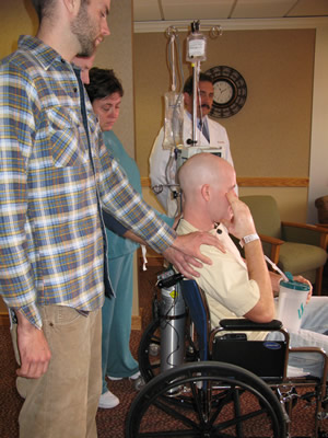 Joshua Gately, left, comforts his brother, Jacob during an emotional news conference Tuesday at the Vail Valley Medical Center.