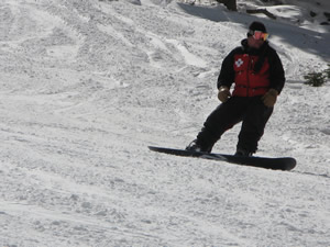 Boarder patrol: A Loveland ski patroller on a snowboard carves a turn Friday, Oct. 19, high atop the Continental Divide at Loveland Ski Area - the second resort in the state to open for the season.