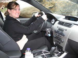 Stacey Anderson, a regional spokeswoman for Ford Motor Company, shows off the new SYNC system in the Ford Focus, which allows hands-free, voice-activated coordination of wireless and digital media devices.