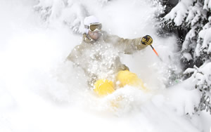 Vail has received 10 feet of snow this season and more than 66 inches in December alone. As an economic incentive, the resort has rolled back lift tickets at all five resorts, will open 30 minutes earlier, and will have 5,100 powder-filled acres to rip on Vail Mountain. Cody Downward is seen here lost in fluff Dec. 19.