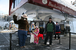 Snow ranger Don Dressler, right, is sort of a Smokey the Bear, left, on skis, who does his best to educate kids on the wild character of public lands in and around ski resorts.