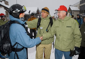 Colorado Sen. Ken Salazar and Eagle County Commissioner Arn Menconi, founder of SOS Outreach, work the crowd Saturday during a rebranding ceremony in which SOS announced its new name and the fact it will now teach skiing in addition to snowboarding.