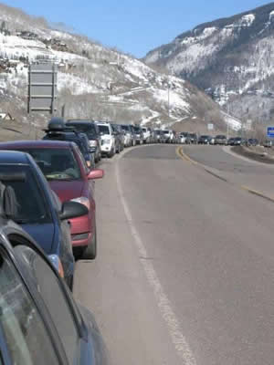 Cars line South Frontage Road on a recent weekday - another sign that day skiers are out in force in Vail. Critics of the new Epic Pass are afraid the traffic and parking woes will only get worse.