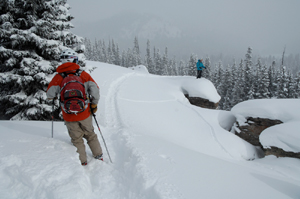 Onie Bolduc, background, checks a route down a set of cliffs while the author, foreground, prepares to pick his line.