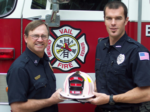 Vail firefighters Cooter Overcash and Ryan Sutter show off the pink helmet they'll be auctioning at Friday's Celebration of Life Luncheon to benefit the Vail Breast Cancer Awareness Group.