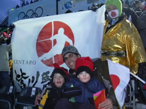 Nick and Max Williams chill out with Dad in front of Japanese ski-racing fans during the 2006 Winter Olympics men's slalom at Sestriere, Italy - a race won by Austria's Benjamin Raich.